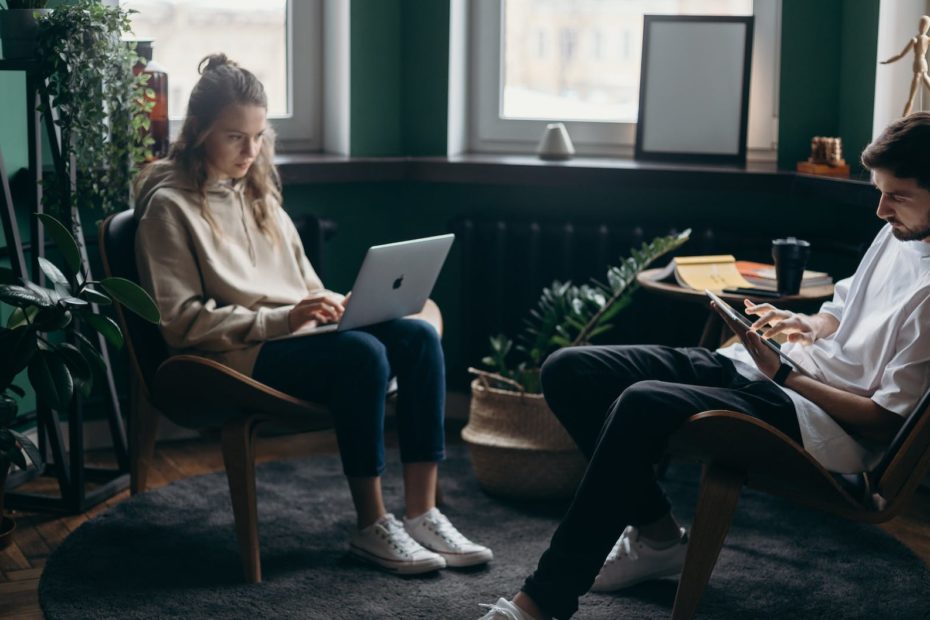 photo of two people using their gadgets